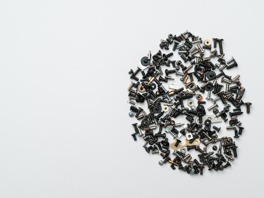A bunch of screws arranged in a circle on a white background, perfect for Nintendo repair enthusiasts.
