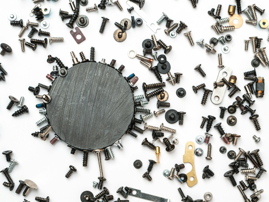 A circle of screws and nuts on a white background.